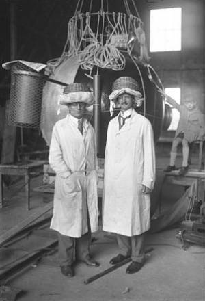 A pair of scientists wearing dapper new hats.